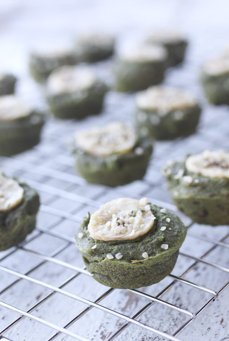 green mini muffins with spinach laid out on a baking tray 