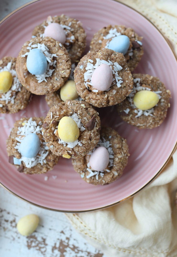 mini egg easter themed snack cups made with granola stacked on a pink plate 