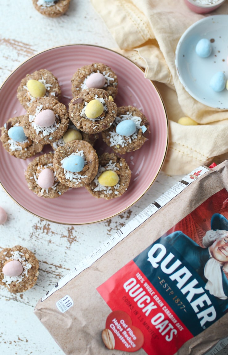 birds eye image of pantry staple easter inspired mini egg granola cups on a pink plate next to a bag of quaker oats