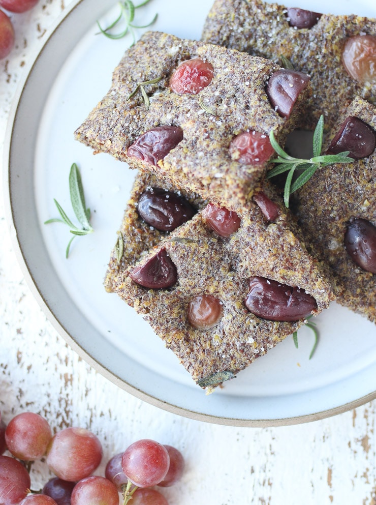 Birds eye view of flax focaccia on a white plate.