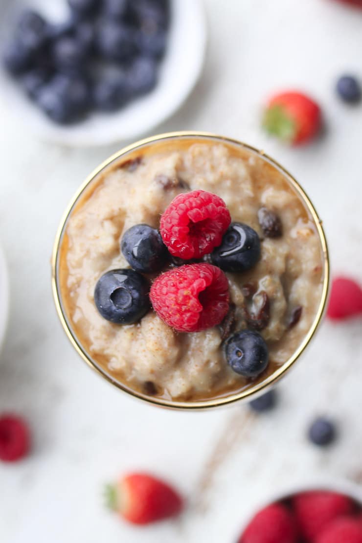 birds eye view of oatmeal pudding dessert topped with raspberries and blueberries 