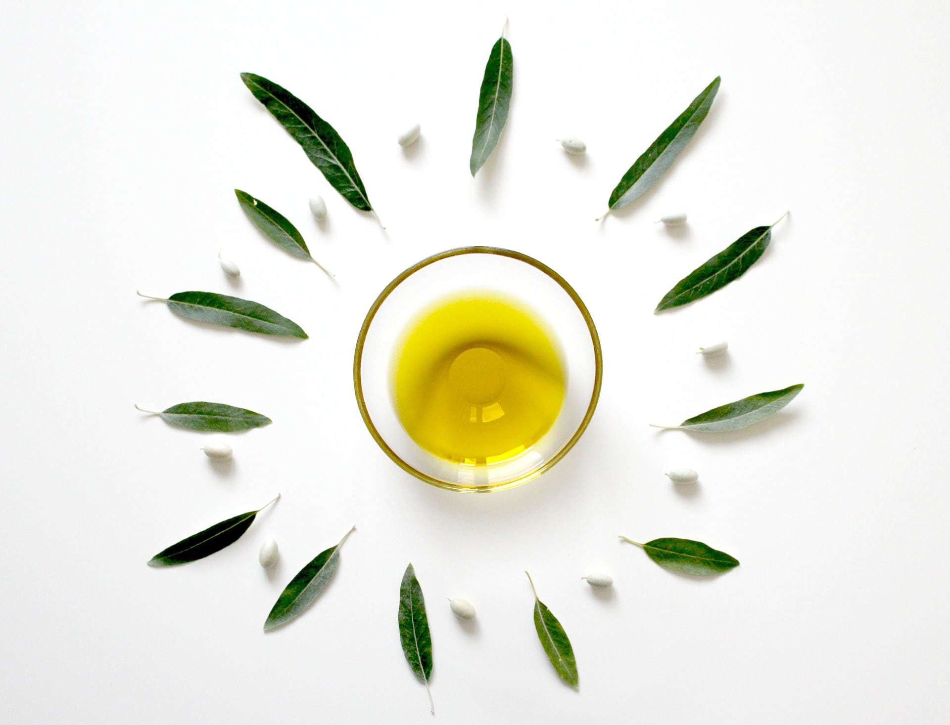 birds eye view of oil in a bowl surrounded by leaves 