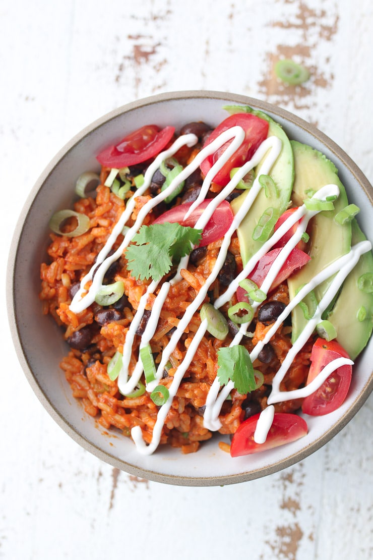 Birds eye view of enchilada bowl drizzled with sour cream.