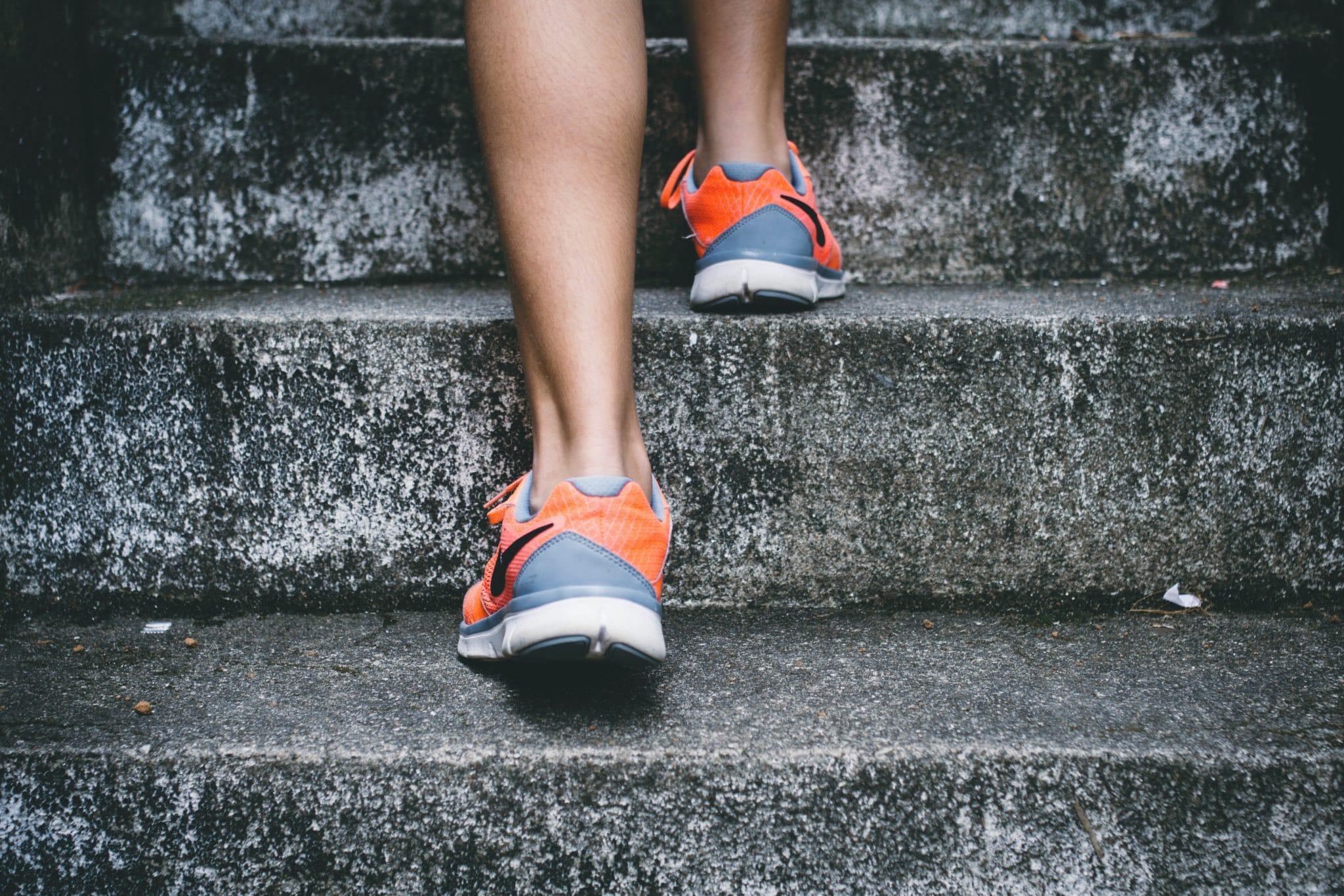 person in running shoes exercising to represent activities that may assist with pregnancy