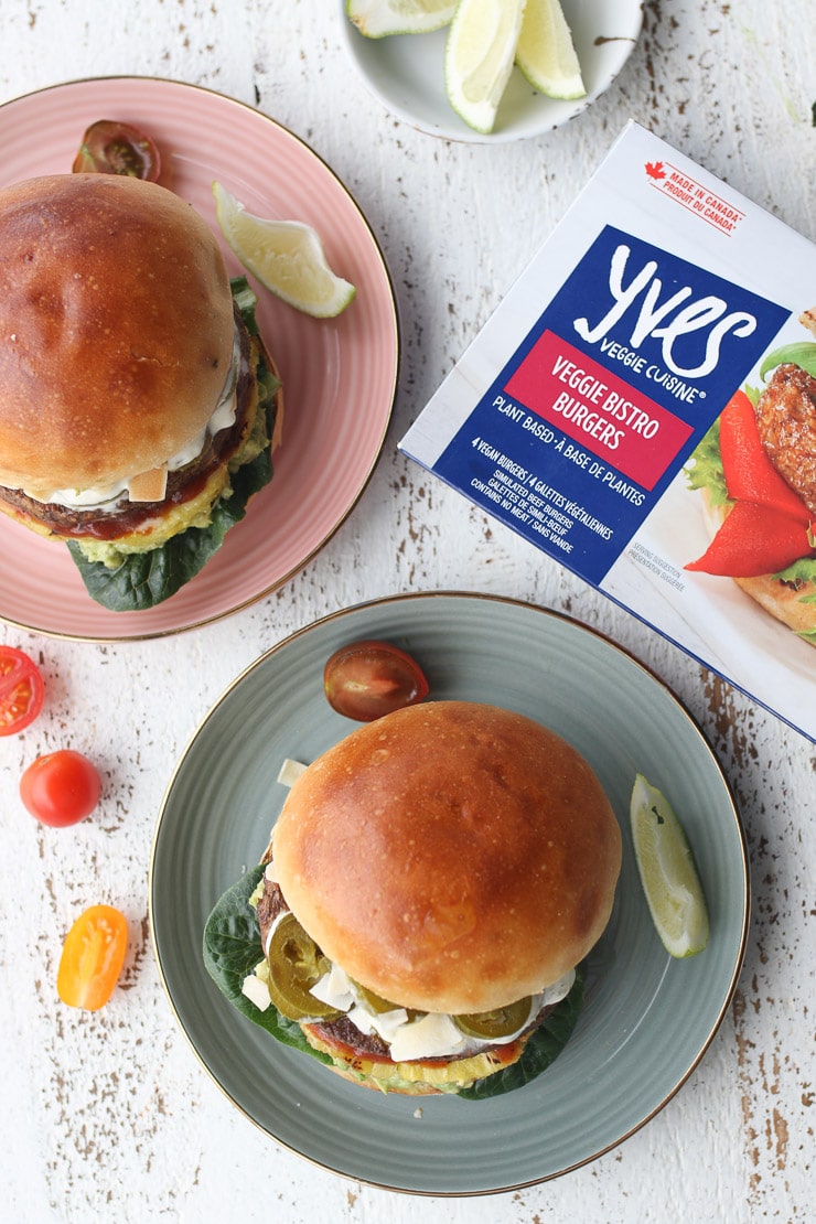 two Hawaiian veggie burgers on a plate garnished with a lemon wedge