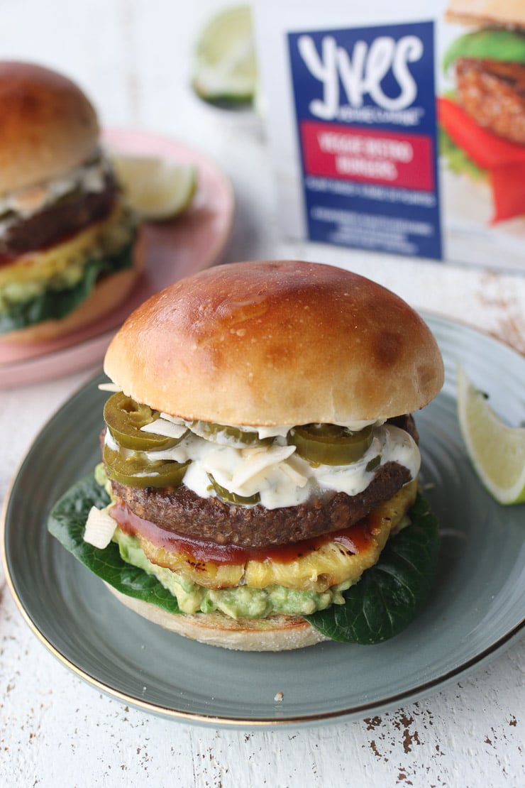 vegan hawaiian burger on a blue plate garnished with a lime wedge