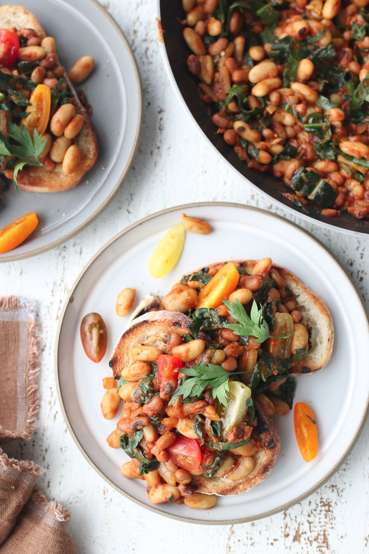 Birds eye view of vegan beans on toast on a white plate.