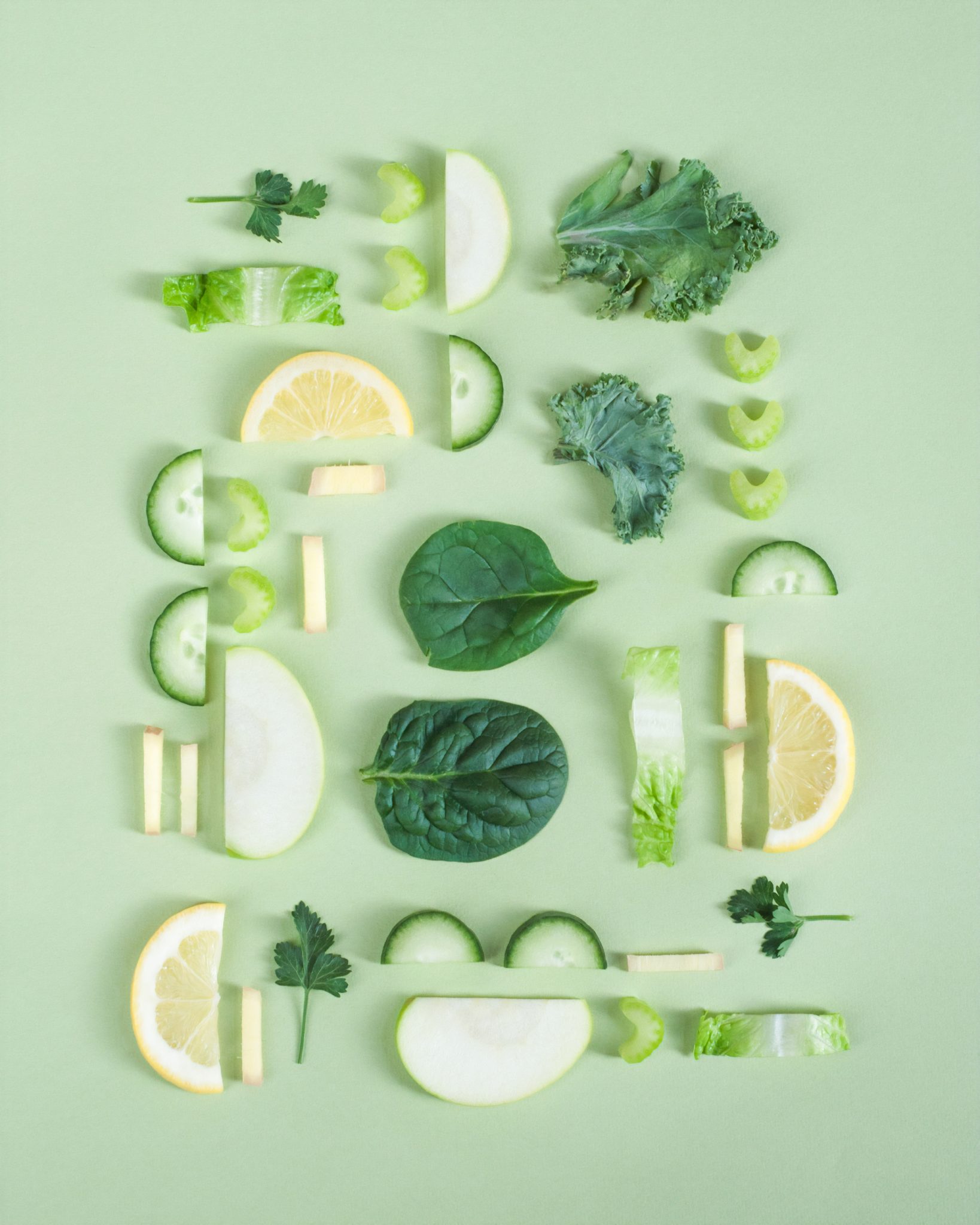 a variety of vegetables like lemon, cucumber and apple cut into moon shapes 