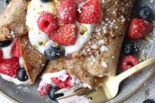 french toast whole wheat wrap stuffed with greek yogurt and berries on a plate