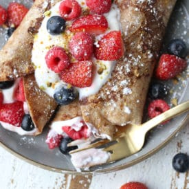 french toast whole wheat wrap stuffed with greek yogurt and berries on a plate