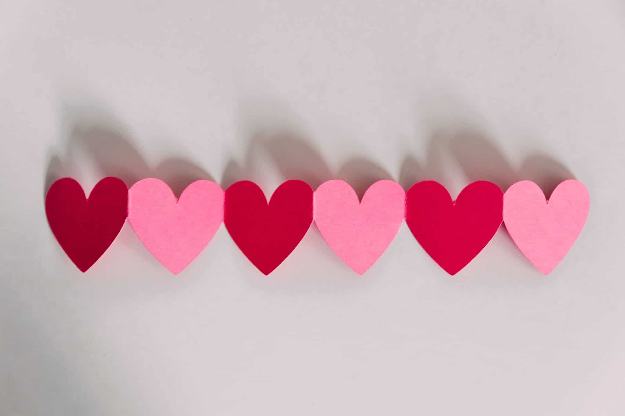 several red and pink paper hearts attached to eat other 