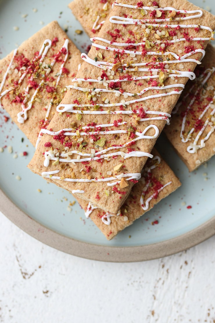 homemade pop tarts drizzled with yogurt and topped with pistachios and freeze dried fruit