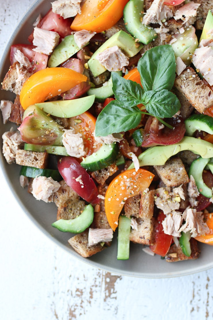 close up of panzanella salad with tuna and avocado 