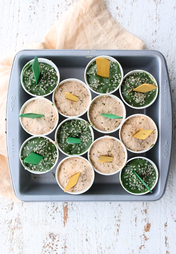 a birds eye view of homemade popsicles in dixie cups on a grey baking tray 