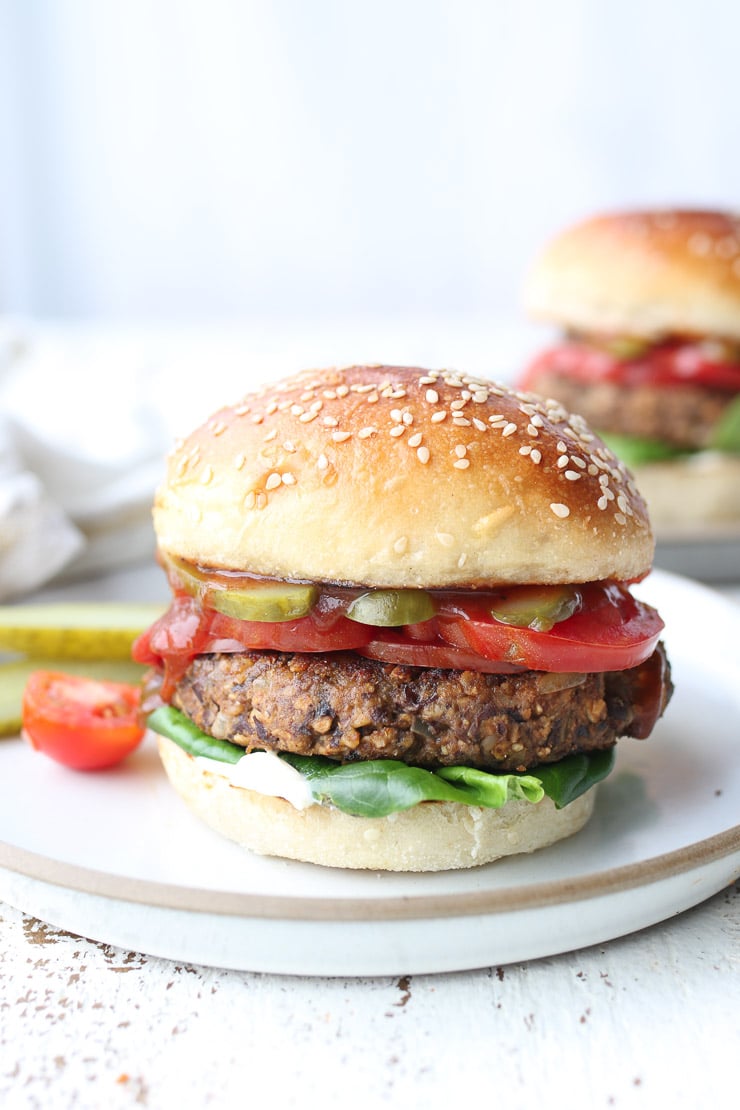 Close up of vegan black bean veggie burger on a white plate. 