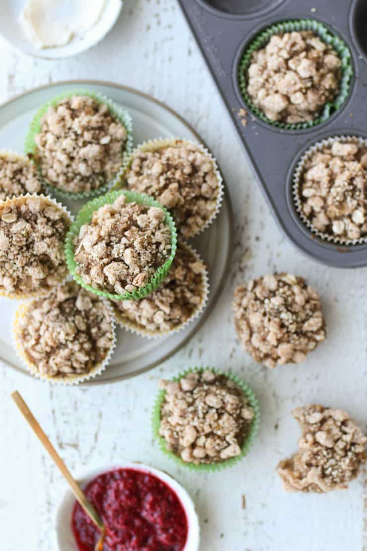 birds eye view of vegan apple oatmeal muffins on a white plate with chia jam on the side 