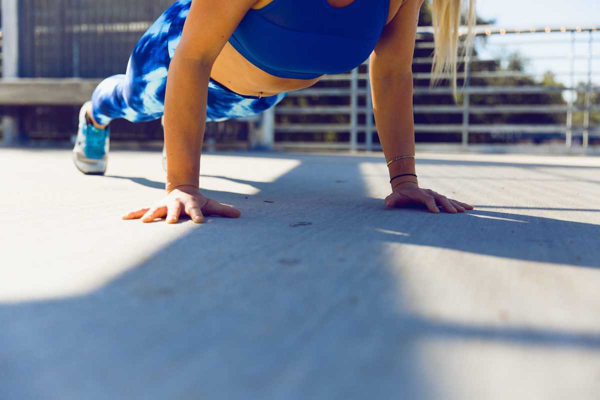 An individual doing a pushup for exercise.