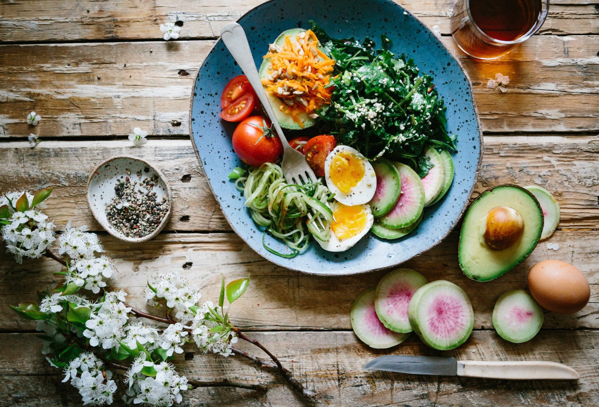 birds eye of a keto bowl with eggs, avocado, and veggies 