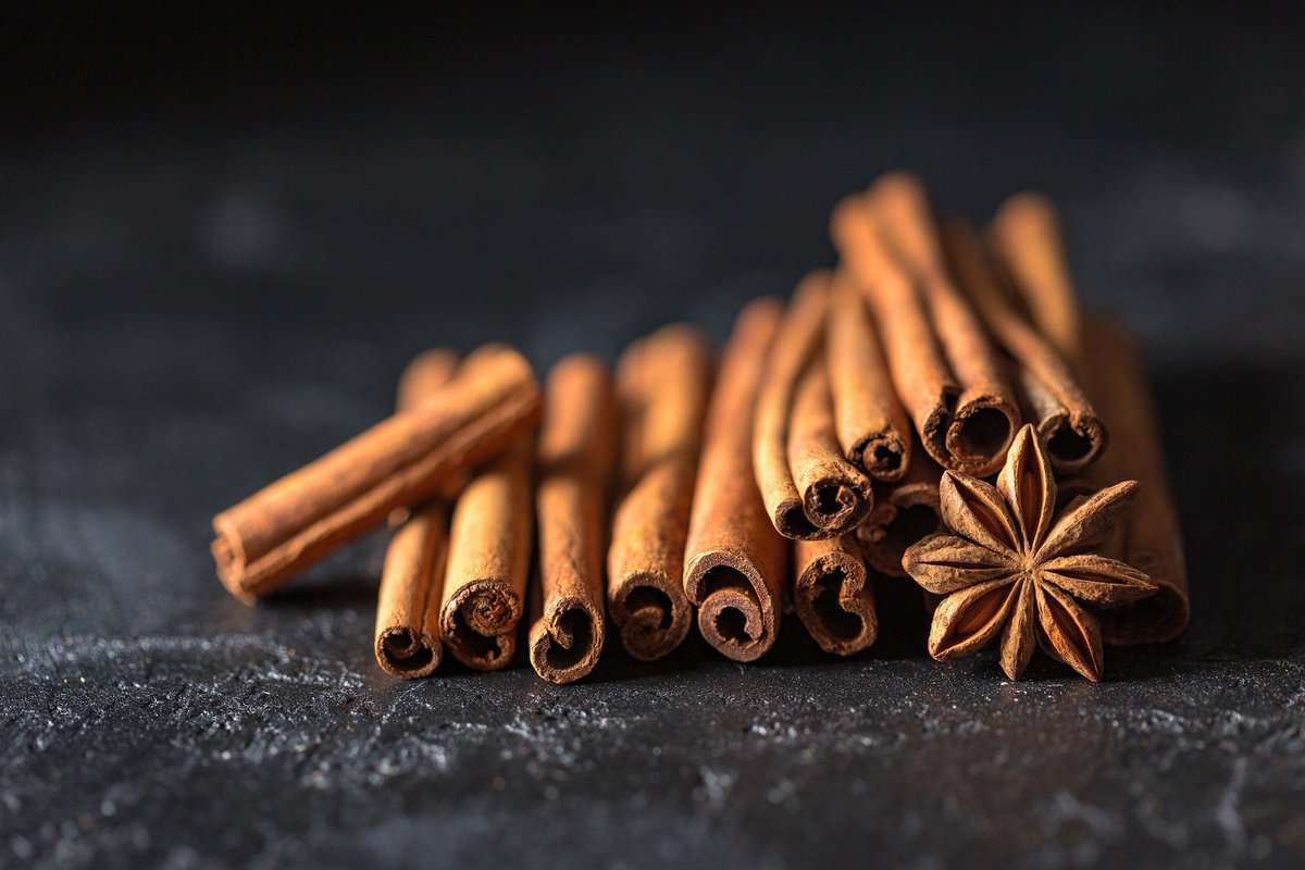 Several cinnamon sticks on a counter.