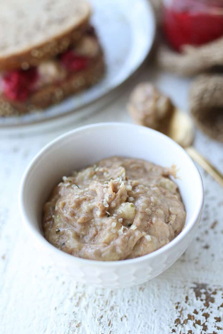 close up of homemade peanut butter in a white bowl.