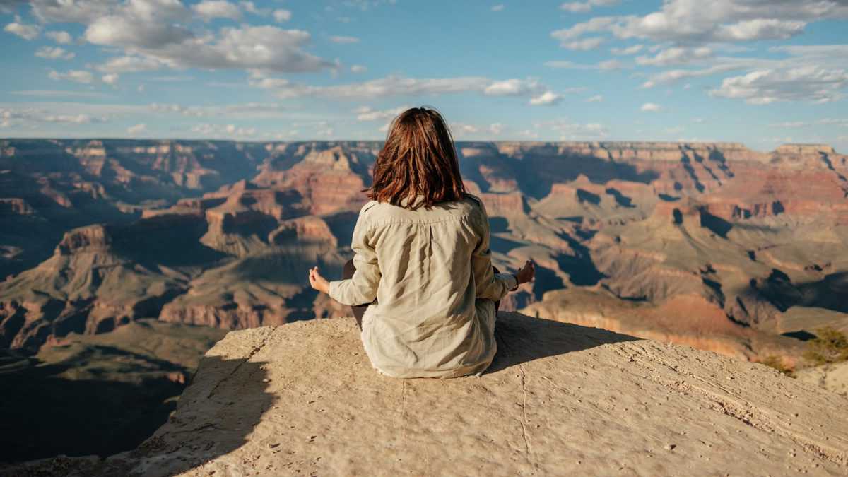 Person meditating to reduce stress to help fix slow metabolism.