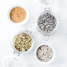 several seeds in jars for seed cycling