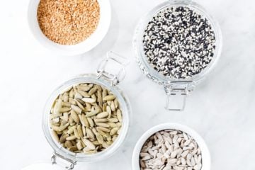 several seeds in jars for seed cycling