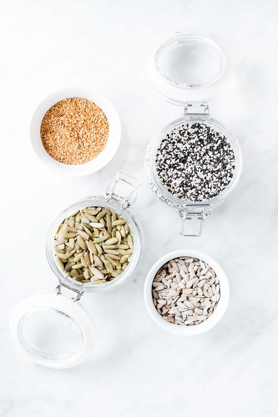 Birds eye view of various seeds in jars for seed cycling.