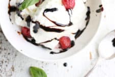 ice cream in a white bowl drizzled with balsamic glaze