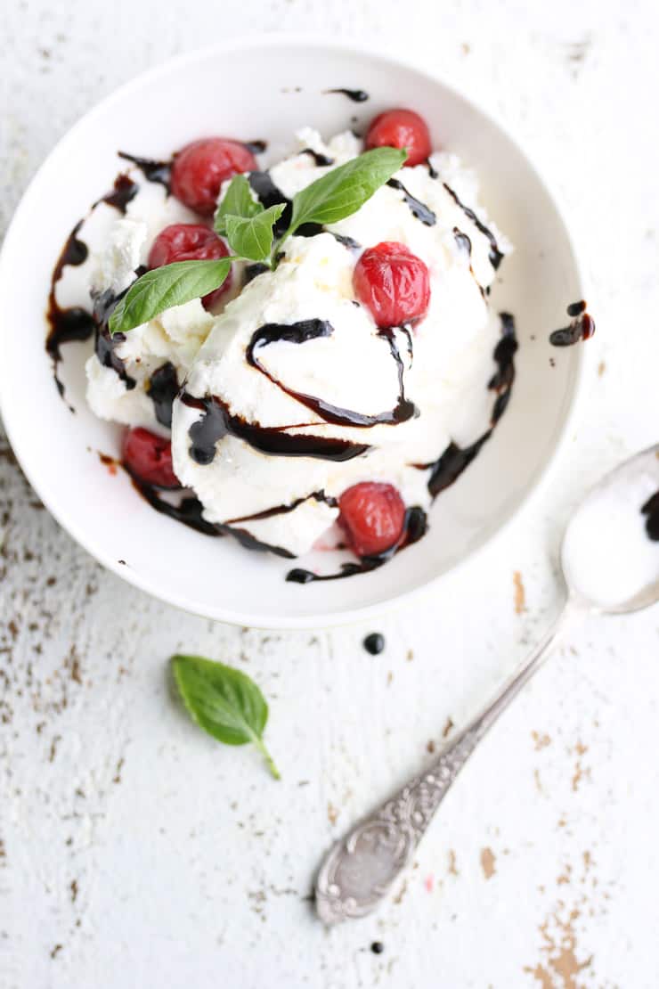 ice cream in a white bowl drizzled with balsamic glaze 