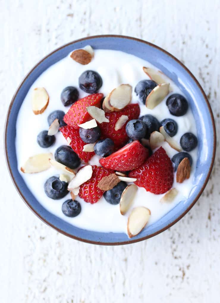 image of nuts, berries, and yogurt in a blue bowl as a healthy snack 