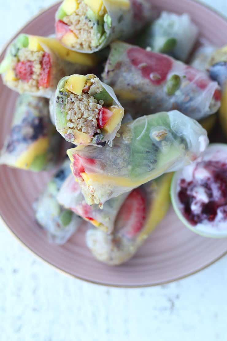 fruit spring rolls on a pink plate.