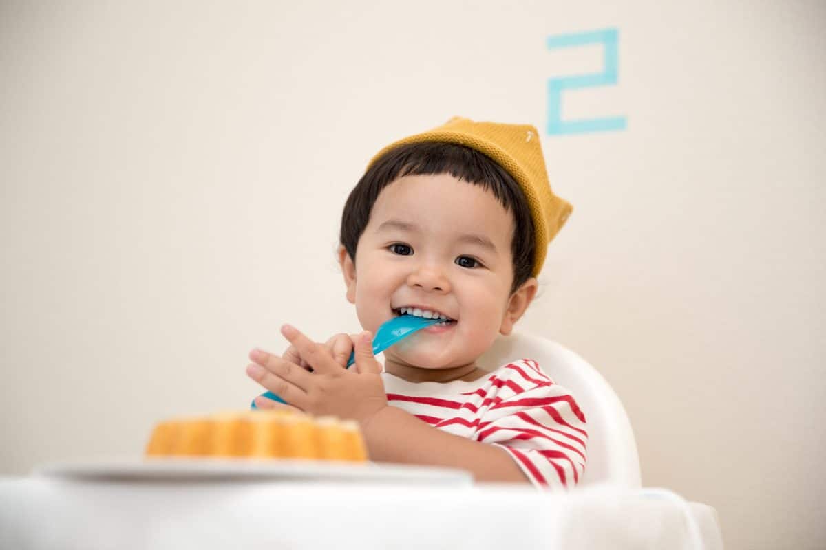 toddler eating in a high chair