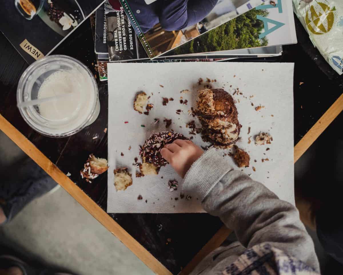 birds eye view of a small child eating dessert with their meal