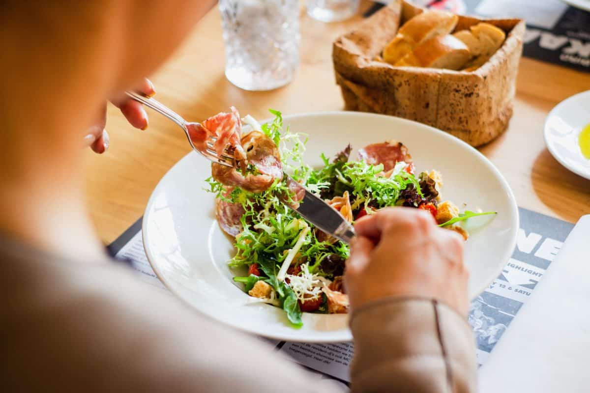 Person eating a salad to change their weight set point.