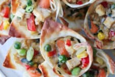 close up of wonton snacks on a white plate