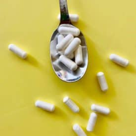 several probiotic capsules on a spoon