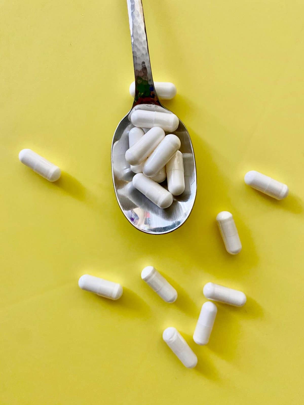 several probiotic capsules on a spoon 