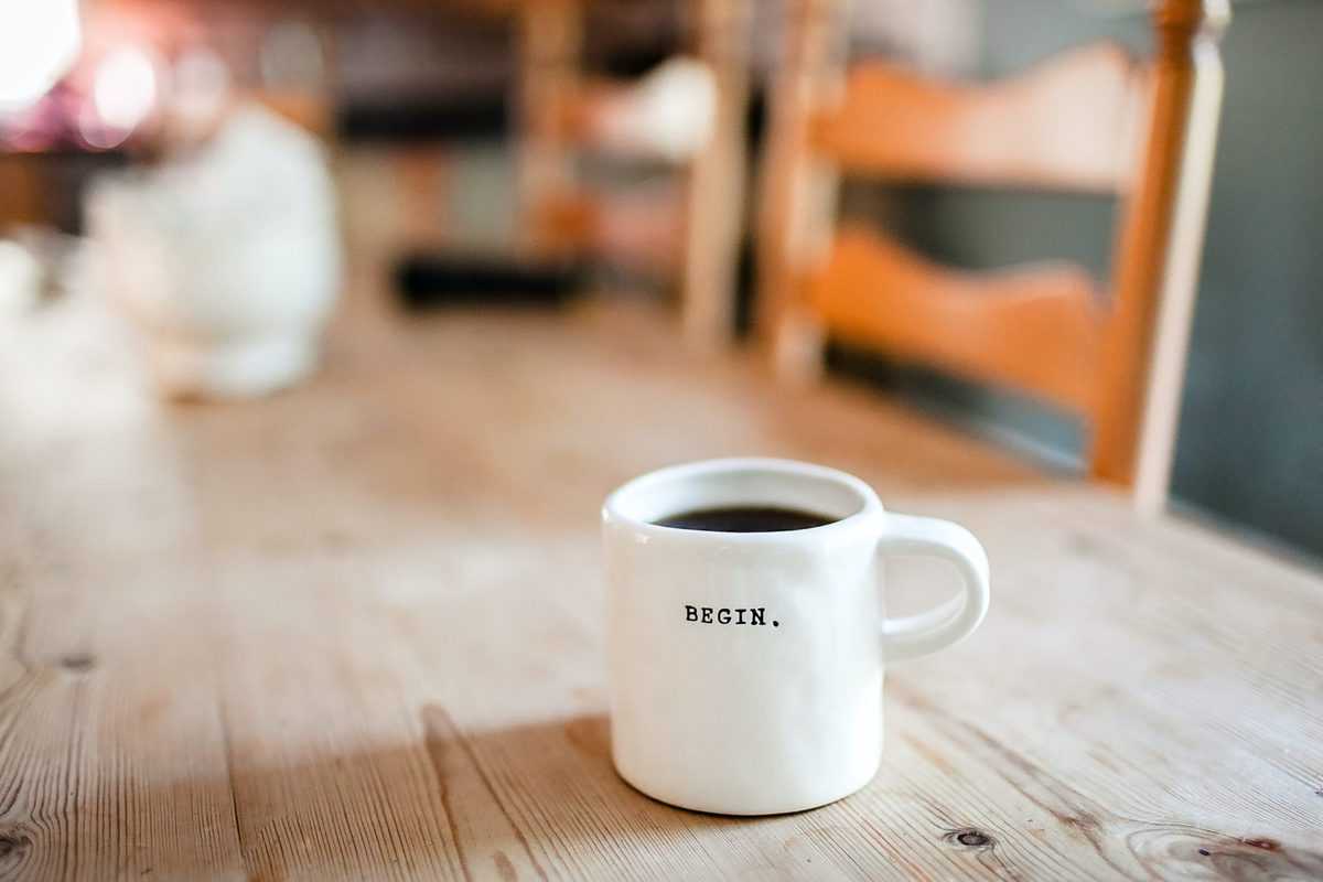 A white coffee mug on a table. 