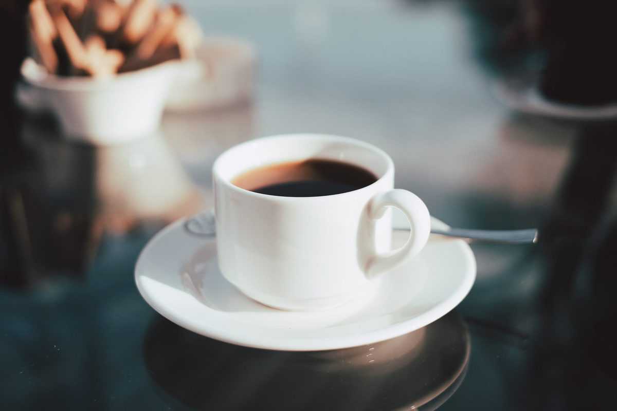 Coffee mug served on a saucer.