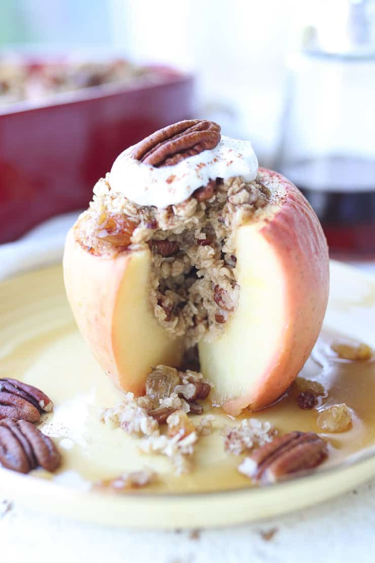 Close up image of healthy baked apples on a yellow plate.