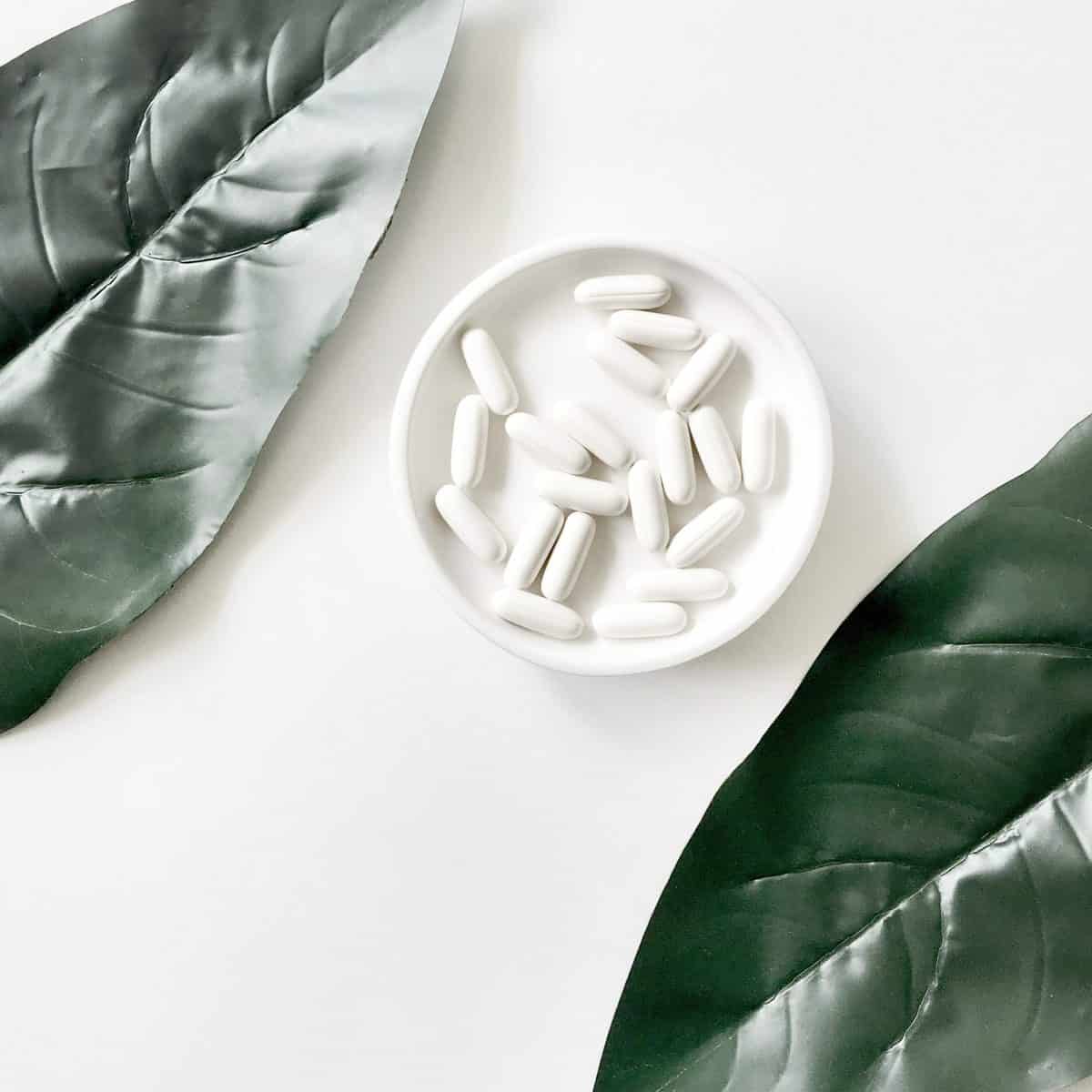 Probiotic pills in a white bowl