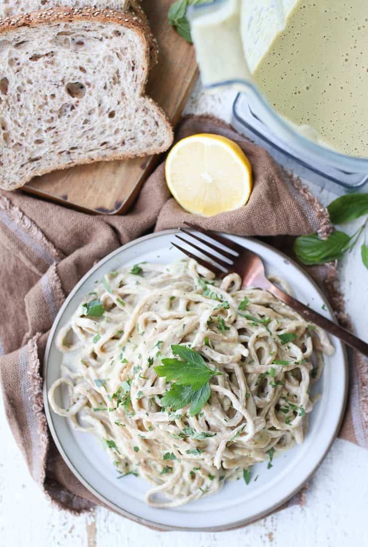 birds eye view of vegan alfredo pasta on a white plate 