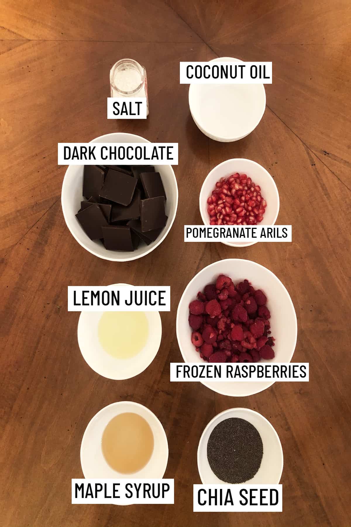 Birds eye view of all ingredients needed to make chocolate cups with chia jam all portioned into individual bowls.