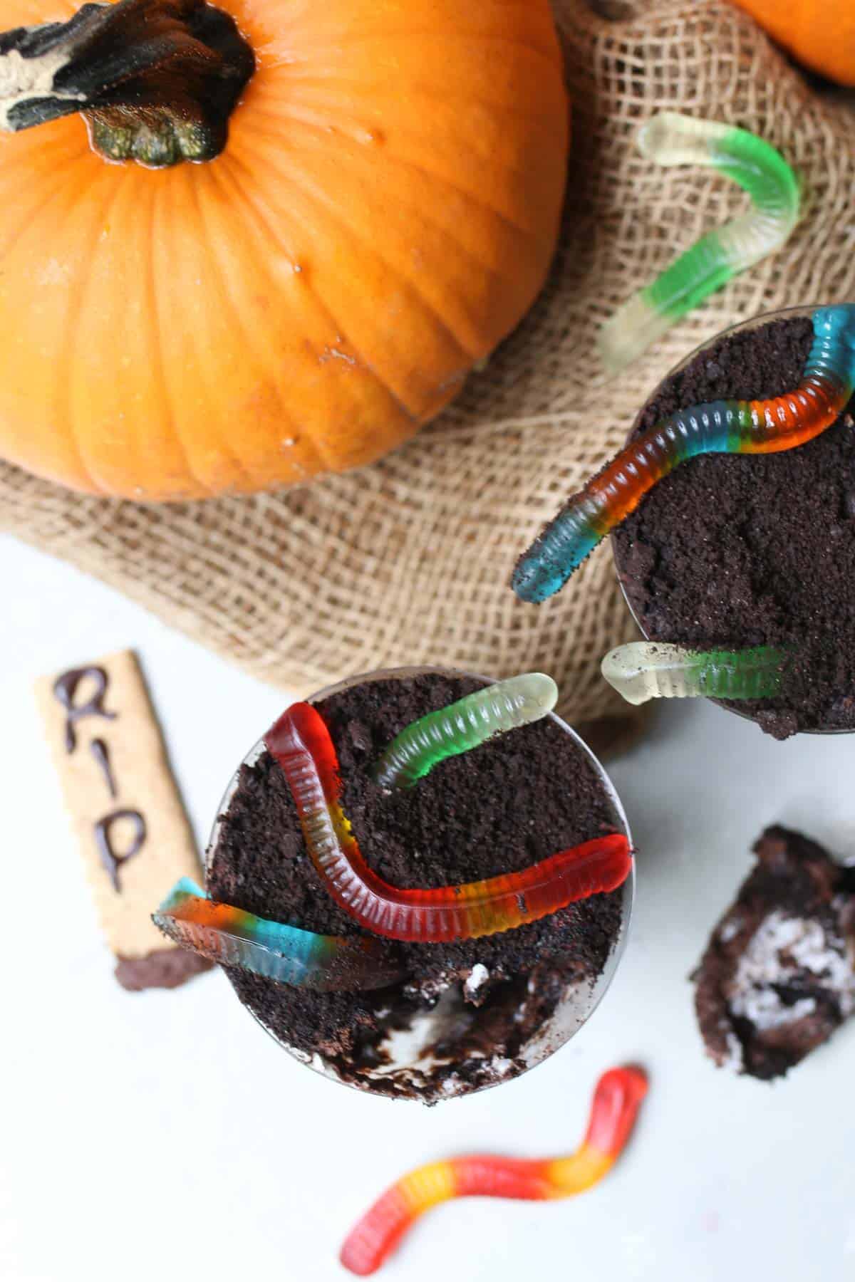 birds eye view of halloween dessert cup with a variety of different gummy worms on top.