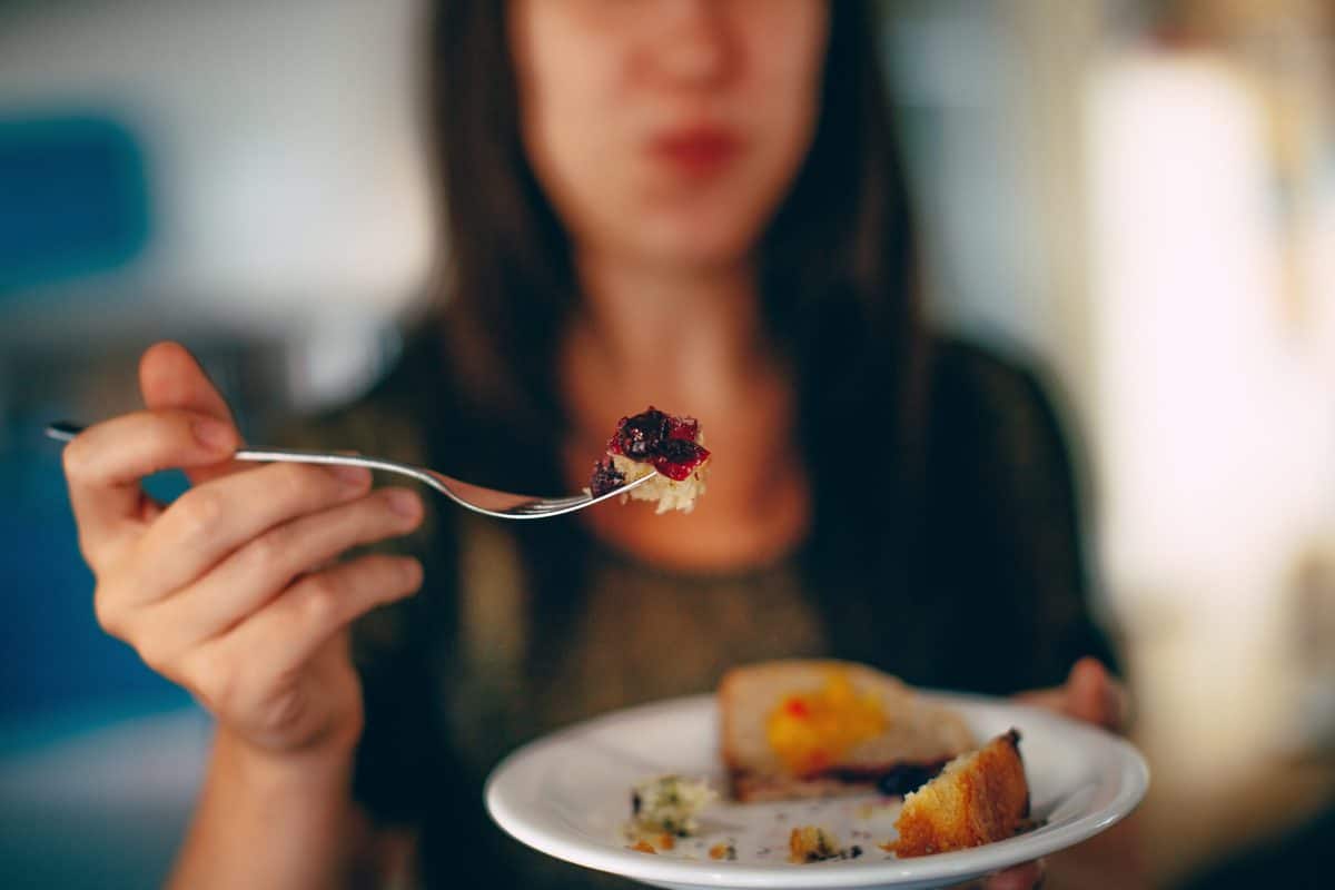 Girl holding out a plate of food for weight loss.