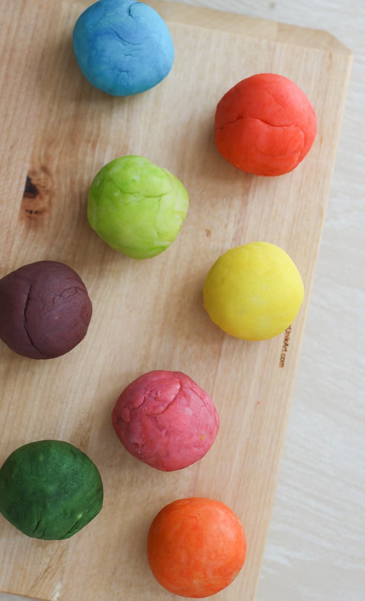 several colourful balls on a wooden board 