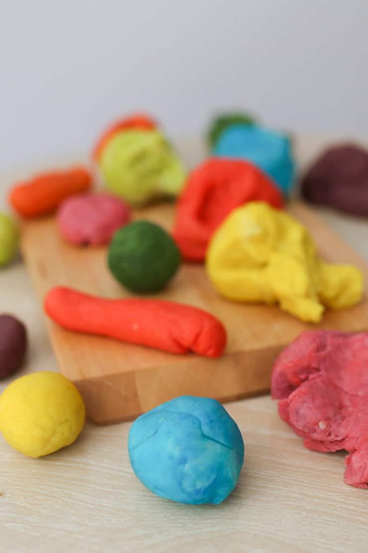 homemade playdough in a variety of different colours and shapes 