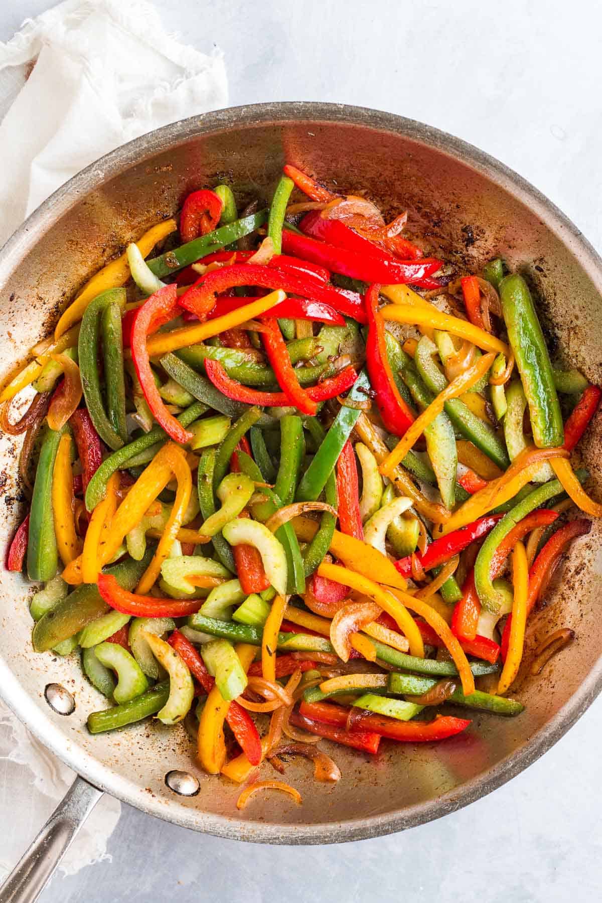 Sauteed vegetables in a grey frying pan.
