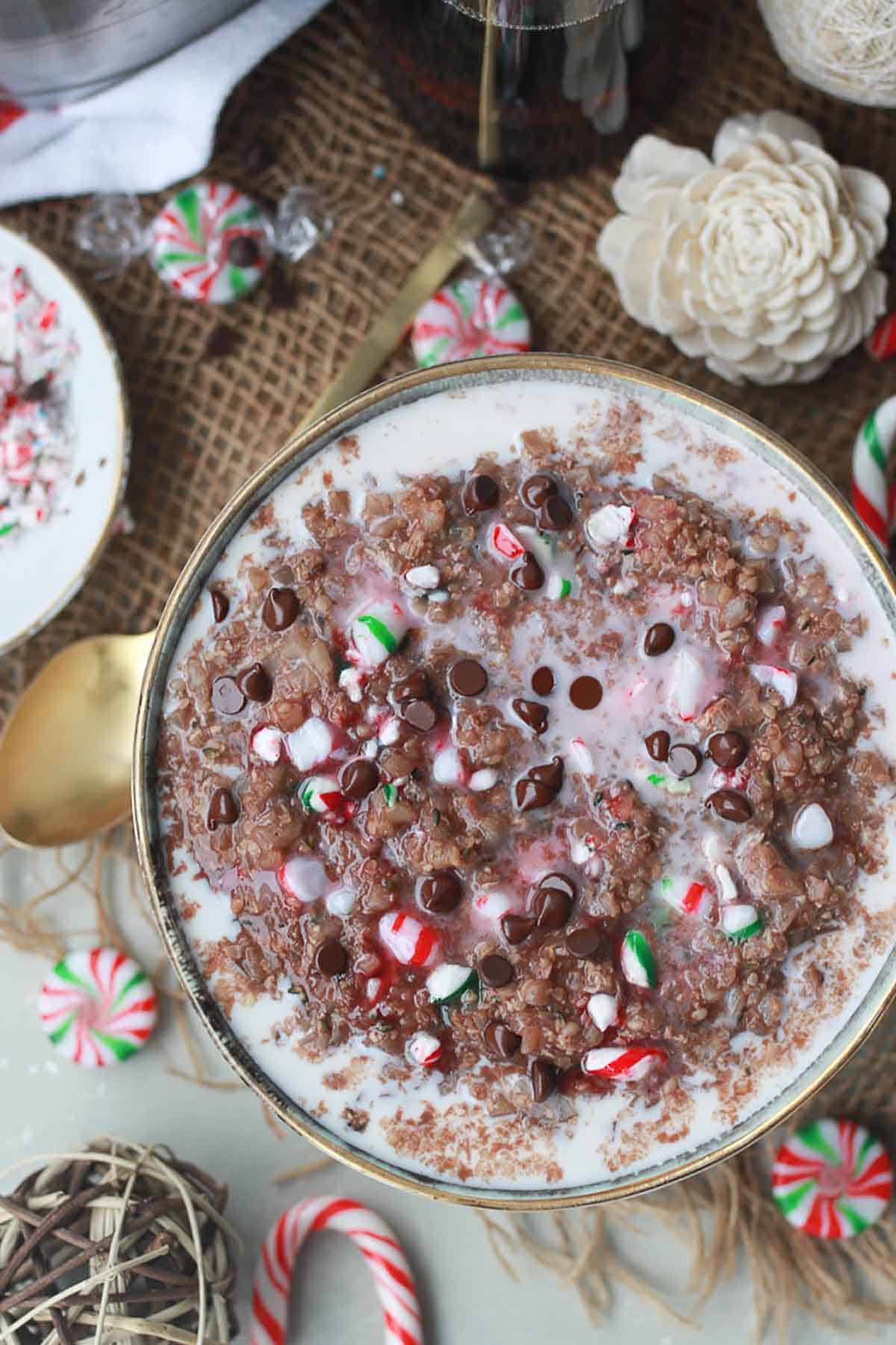 Birds eye view of protein porridge oats with peppermint surrounded by candy canes.